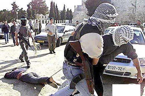 Soldiers of Palestinian Authority drag a victim on the streets
